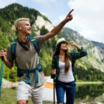 Adventure, travel, tourism, hike and people concept. Group of happy friends with backpack outdoors