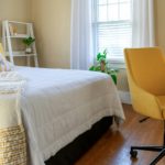 Small stylish bedroom decorated in yellow and white