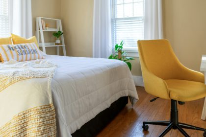 Small stylish bedroom decorated in yellow and white