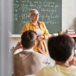 Teacher teaching students at school