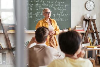 Teacher teaching students at school