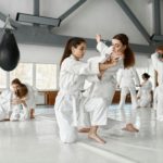 Teenage girls fighting at aikido training in martial arts school