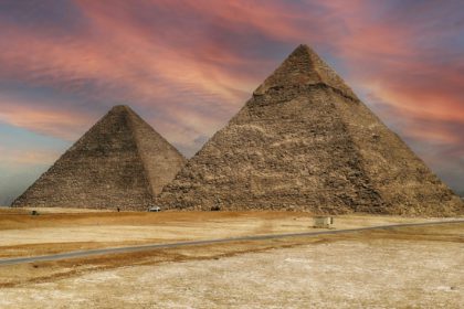 View of the pyramids of Giza in Egypt against a colorful sunset sky