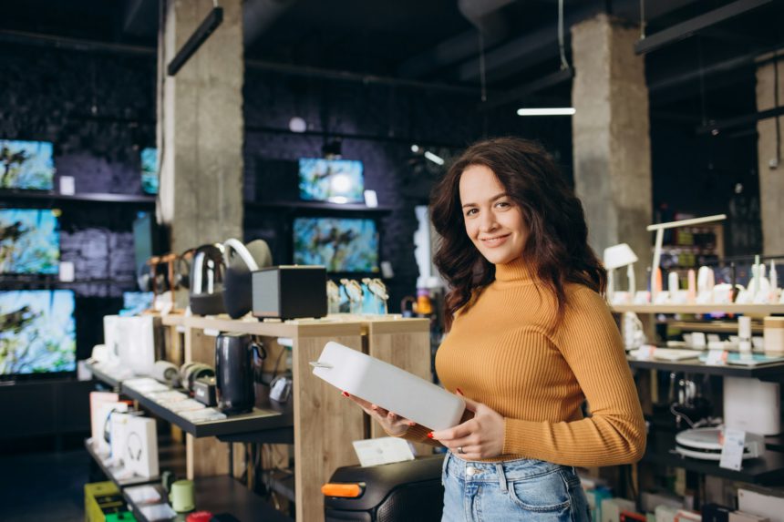 woman in an electronics store with a purchase