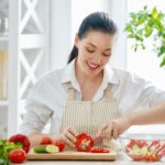 woman is cooking vegetables