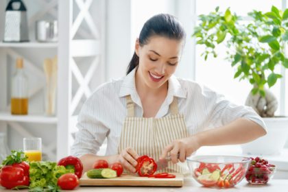 woman is cooking vegetables