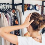 Woman near her open home wardrobe. Space organizer. Storage organization concept