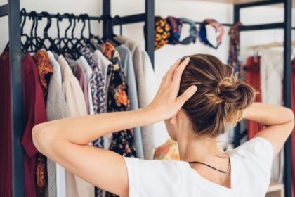 Woman near her open home wardrobe. Space organizer. Storage organization concept