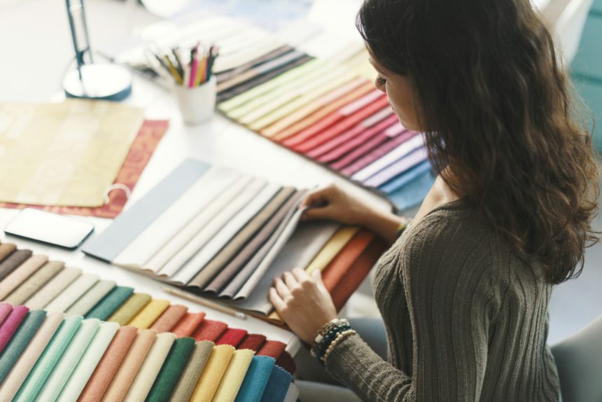 Young interior designer choosing fabric samples